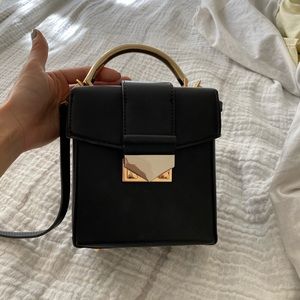 Mango black Satchel with gold accent. NWOT